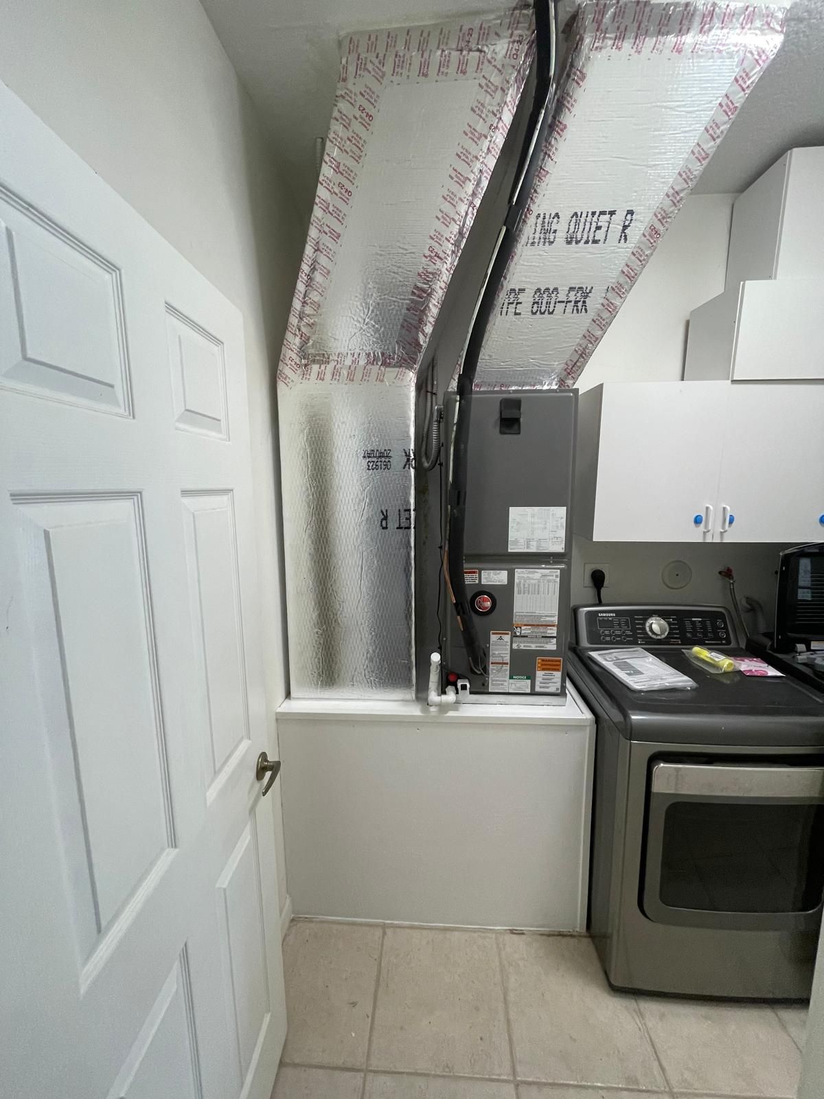 Air handler in a laundry closet with an insulated supply plenum