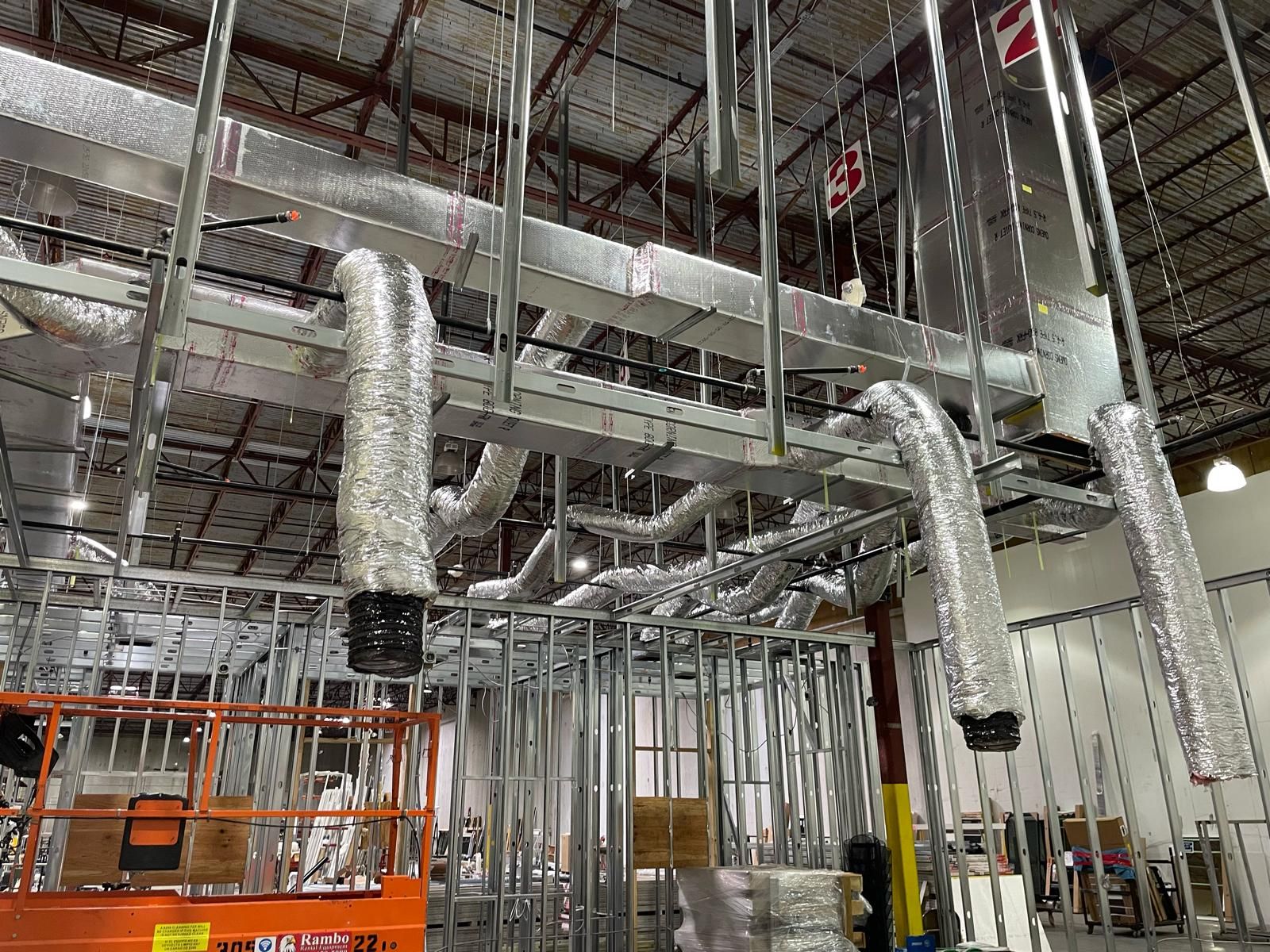 Spiral trunk with insulated flex branches running through metal framing